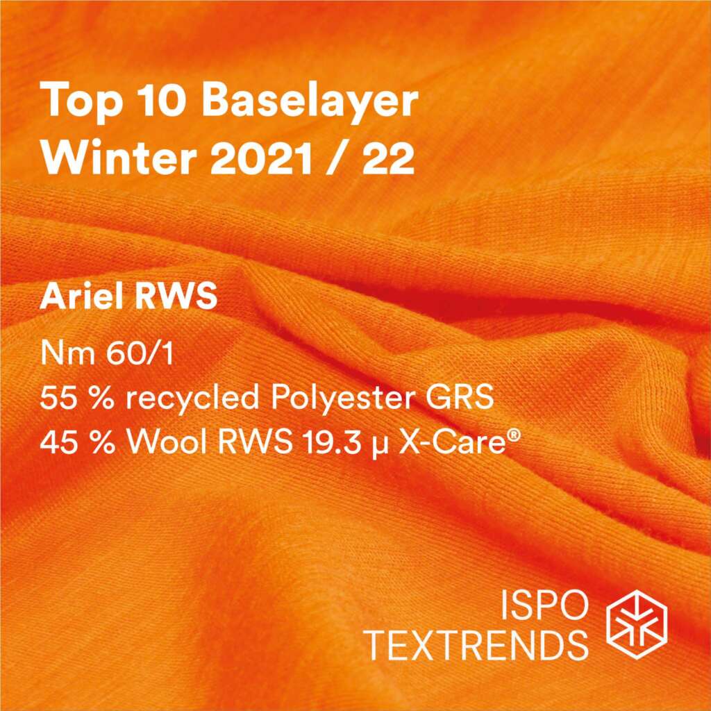 Bright orange fabric with text: Top 10 Baselayer Winter 2021/22. Ariel RWS. Nm 60/1. 55% recycled polyester GRS, 45% wool RWS 19.3 µ X-Care®. ISPO Textrends logo at the bottom right.