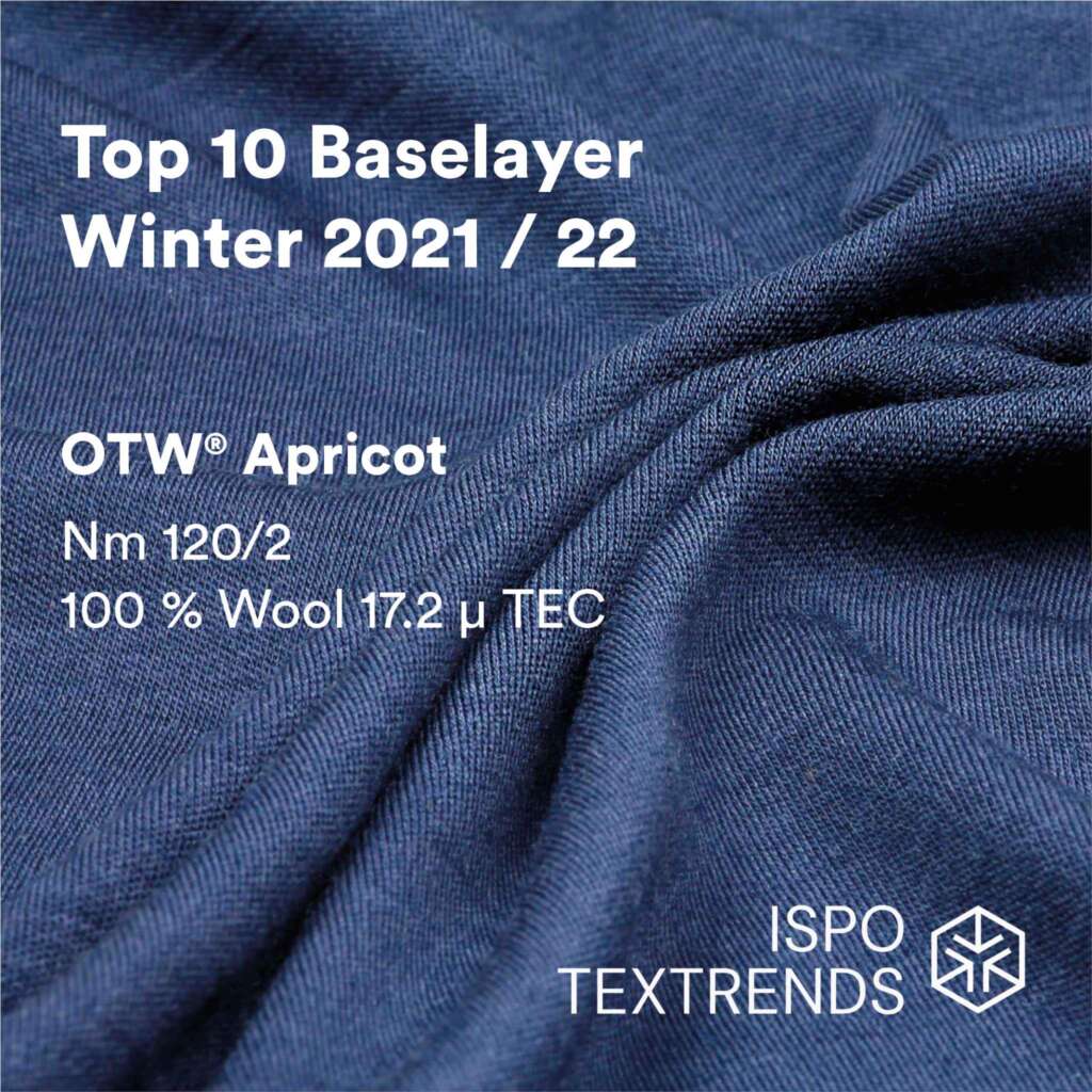 A close-up of blue wool fabric with text about OTW Apricot, a top 10 baselayer for Winter 2021/22, made of 100% wool, Nm 120/2, 17.2 µ TEC. ISPO TEXTRENDS logo is shown.