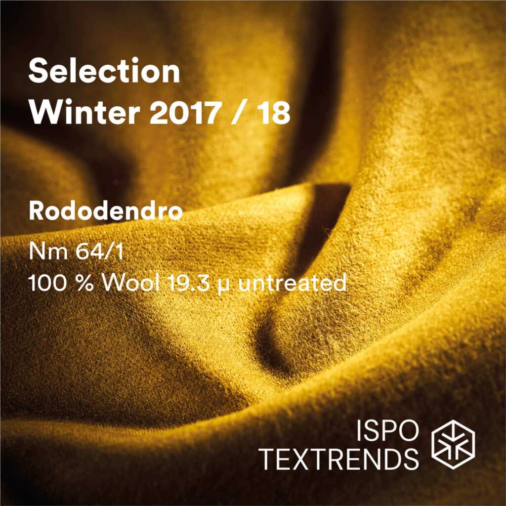 A close-up of soft, golden yellow wool fabric with text overlay about ISPO TEXTRENDS Winter 2017/18 selection, featuring Rododendro, Nm 64/1, 100% wool, 19.3 microns, untreated.